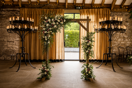Tithe Barn tithe barnwooden arch flowers wedding white pink flowers